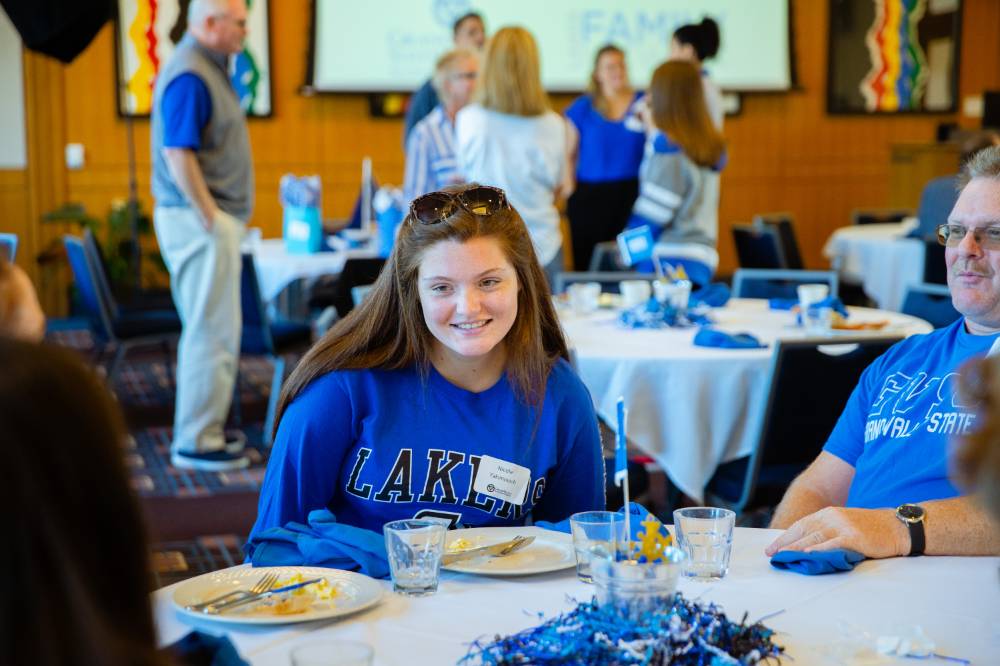 A student enjoying conversation at the table at the Laker Legacy Brunch